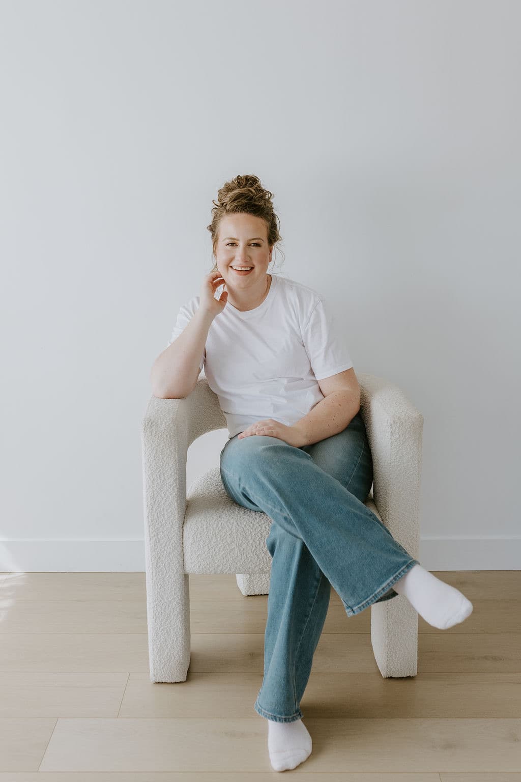 Megan Nakazawa sitting in an armchair, smiling